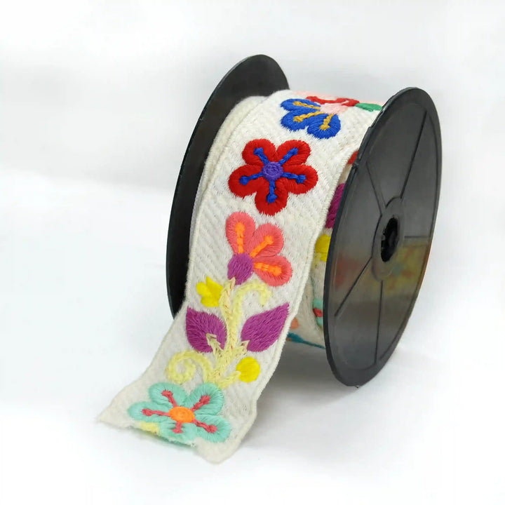 Spool of multicolor small flower crochet laces on a white background| Ani Accessories