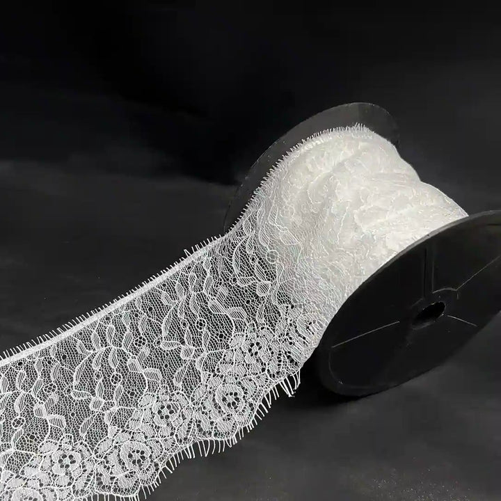 Rose Garden Eyelash Lace applique by Ani Accessories on a spool, featuring intricate floral designs