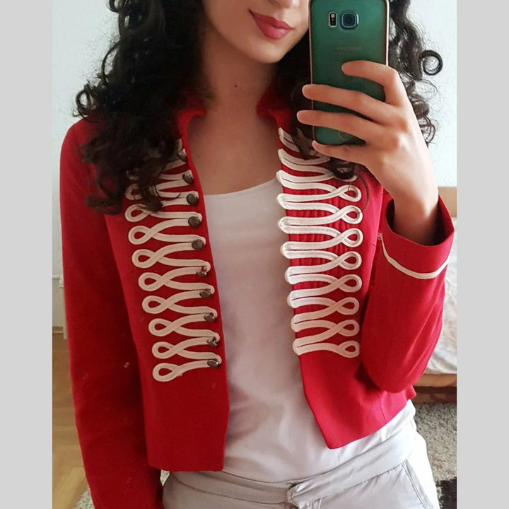 Red cropped military-style jacket with white braided cord loop trim on both front panels and dark metal buttons