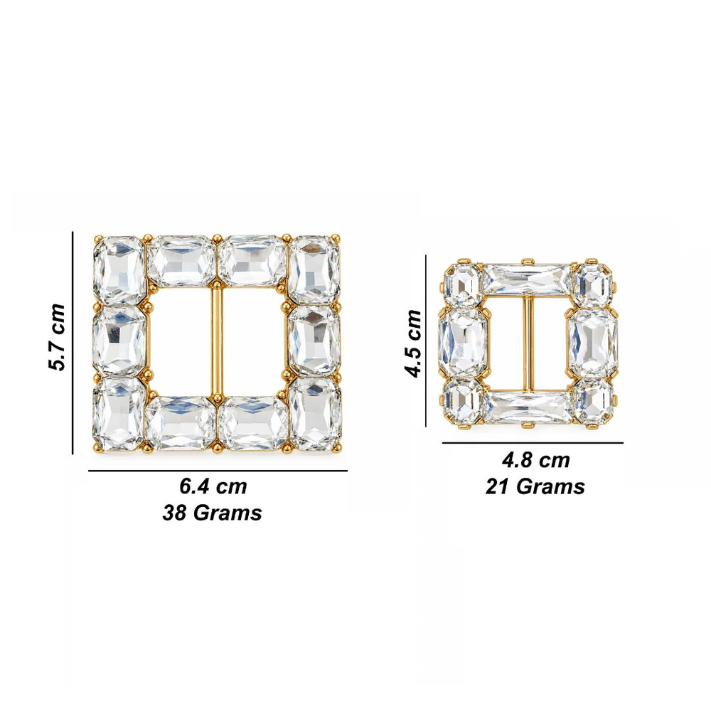 Two square gold-tone buckle-style jewelry pieces with clear rectangular stones, shown with dimension labels and weight text on a white background. One is 5.