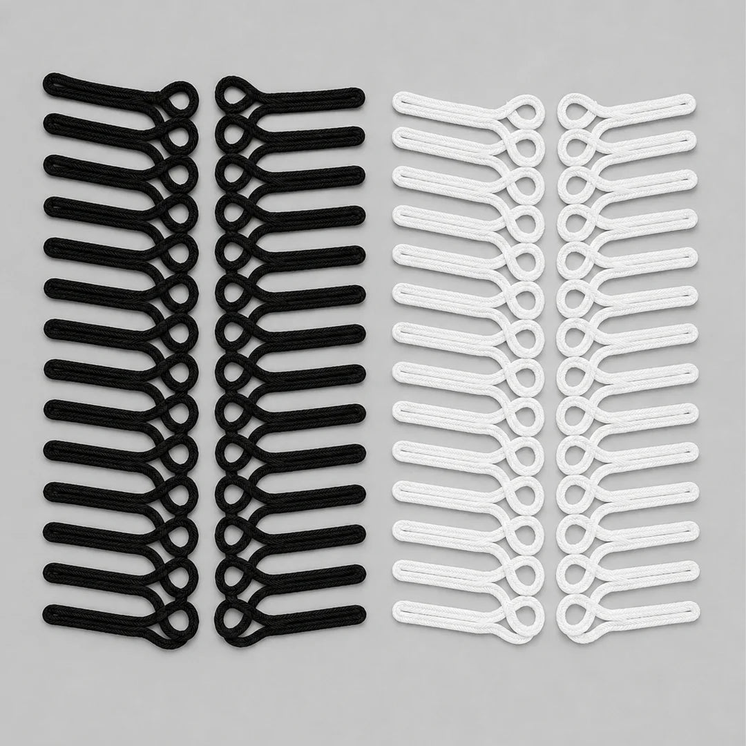 Black and white frog closure braid loop sew-on patches with horizontal cord loops, laid flat in mirrored pairs on grey background