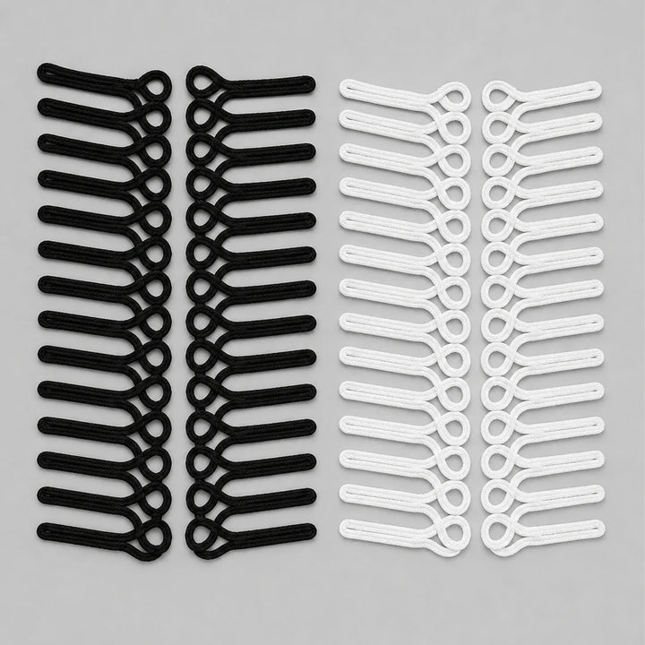 Black and white frog closure braid loop sew-on patches with horizontal cord loops, laid flat in mirrored pairs on grey background