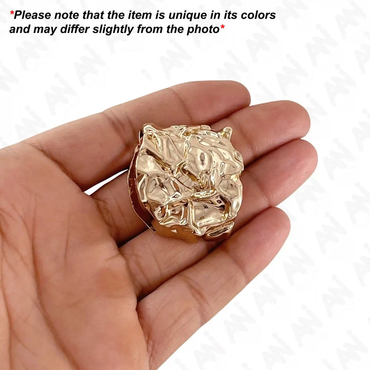 Ani Accessories Aurelian Design Shard Buckle on the hand with text caution on the white background.