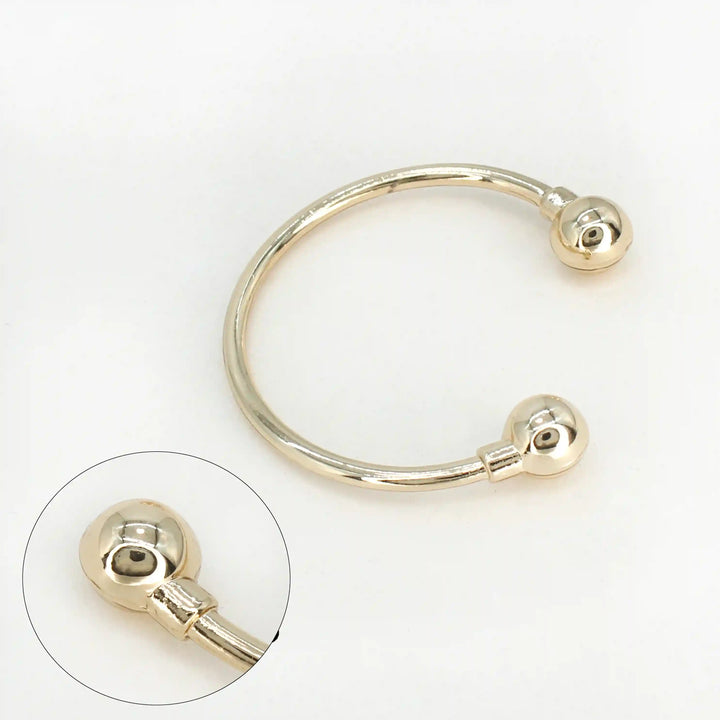 Ani Accessories Curved Circular Elegance Thin Gold Metal Buckle in the white background with zooming image on the tip of the buckle.