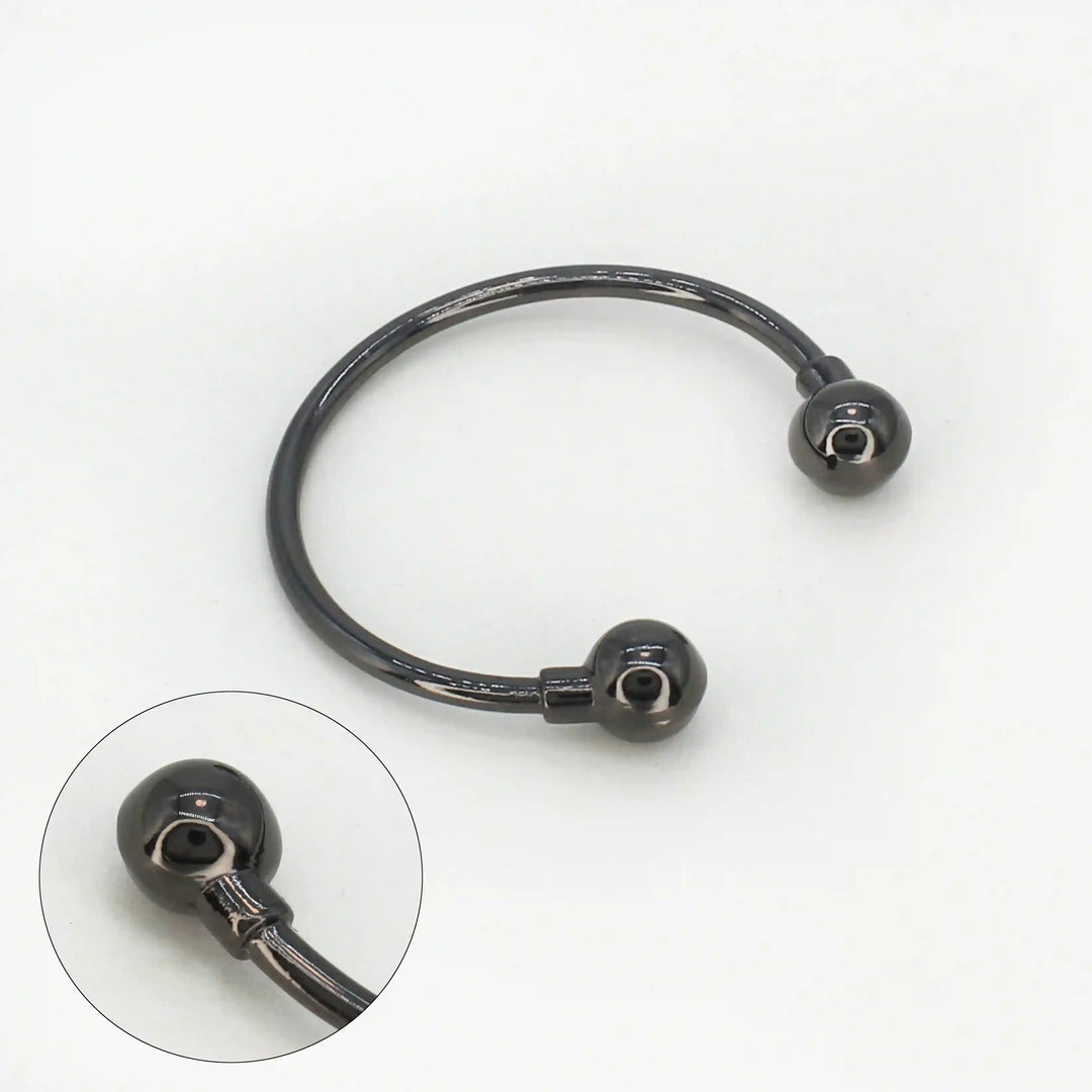 Ani Accessories Curved Circular Elegance Thin Nickel Black Metal Buckle in the white background with zooming on the tip of the buckle to show the design.