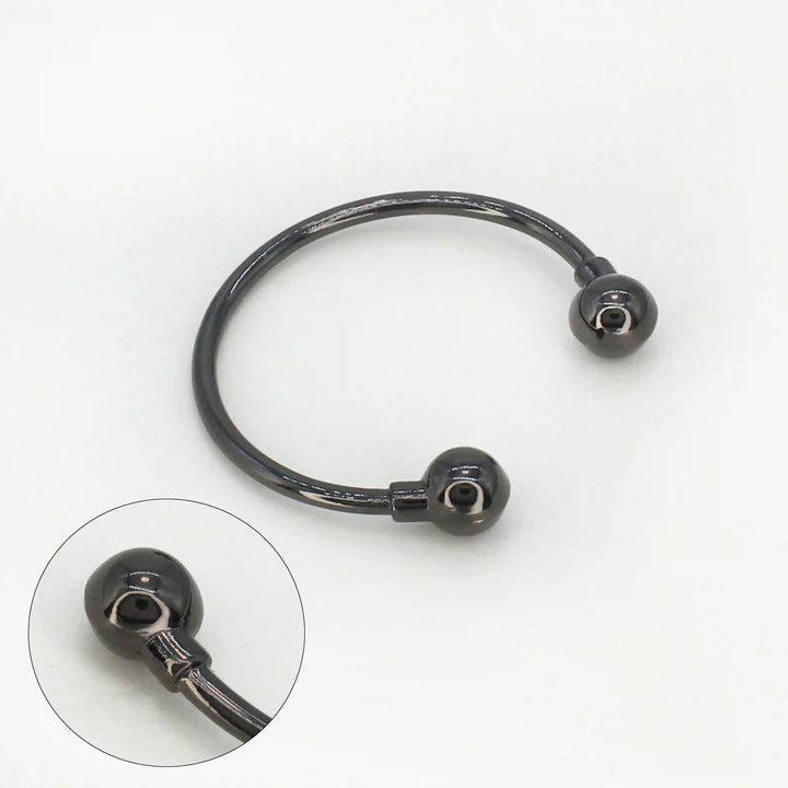 Ani Accessories Curved Circular Elegance Thin Nickel Black Metal Buckle in the white background with zooming on the tip of the buckle to show the design.