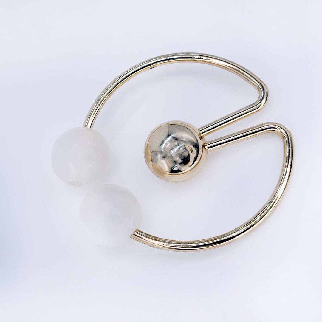 Ani Accessories Dual Pearl With Circular Center Gold Ball Metal Buckle placed on the floor.