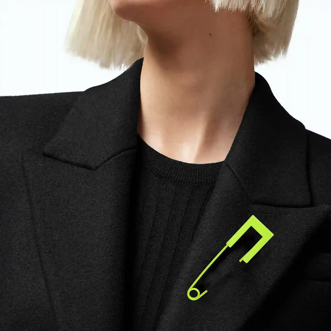 Ani Accessories safety pin worn on female model’s black jacket, perfect for styling as lapel or fashion accessory