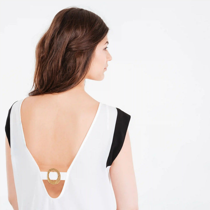 Ani Accessories Flowing  Loop Adjustable Golden Metal Buckle on the strap of the back of the model white top.