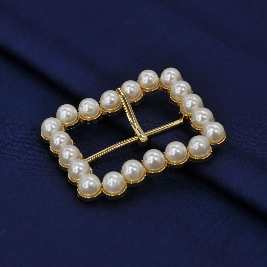 Ani Accessories Gold Finish Shiny Pearl Uneven Shape Prong Buckle  on the velvet cloth to show the proper clear image of the buckle.