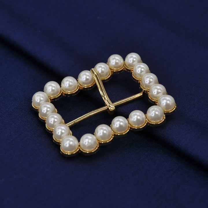 Ani Accessories Gold Finish Shiny Pearl Uneven Shape Prong Buckle  on the velvet cloth to show the proper clear image of the buckle.