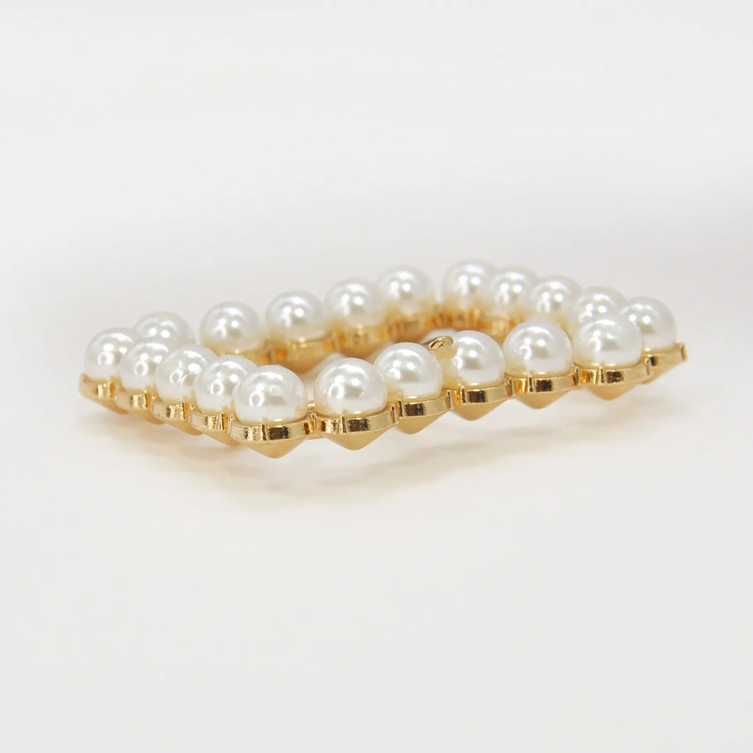 Ani Accessories Gold Finish Shiny Pearl Uneven Shape Prong Buckle side angle on the floor to show the thickness.