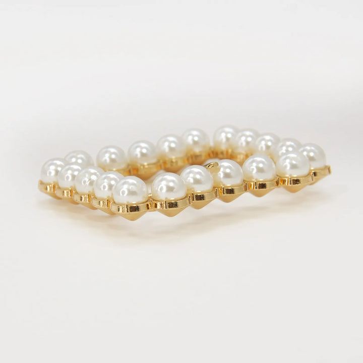 Ani Accessories Gold Finish Shiny Pearl Uneven Shape Prong Buckle side angle on the floor to show the thickness.