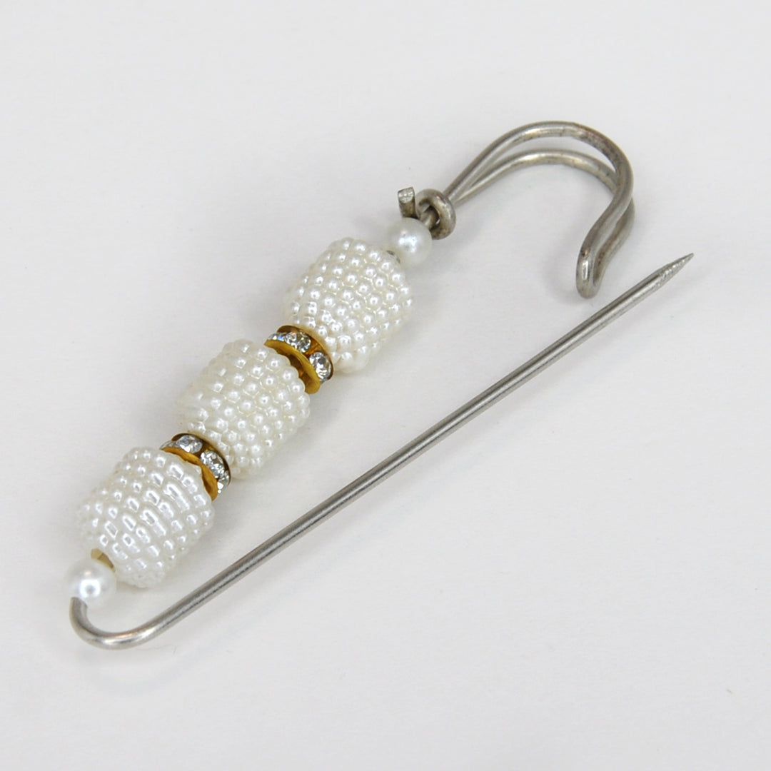 Ani Accessories Pearl brooch with gold accents on a white background