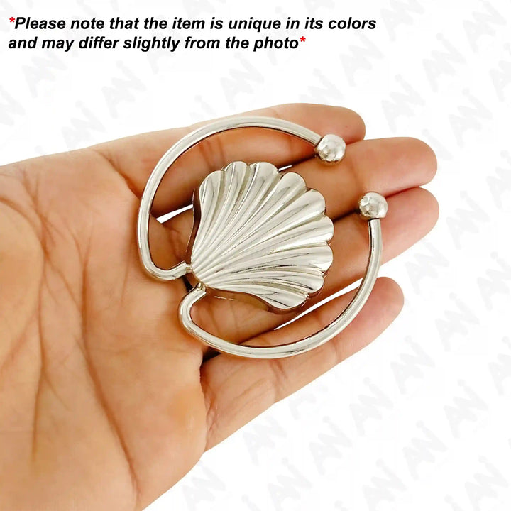 Ani Accessories Scalloped Shell Metal Buckle on the palm caution written on the white background.