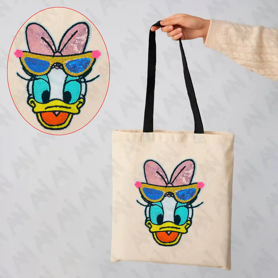 Ani Accessories Sequins Daisy Duck patch shown on bag for women jackets shirts denim jeans and DIY clothing projects with sparkling character design