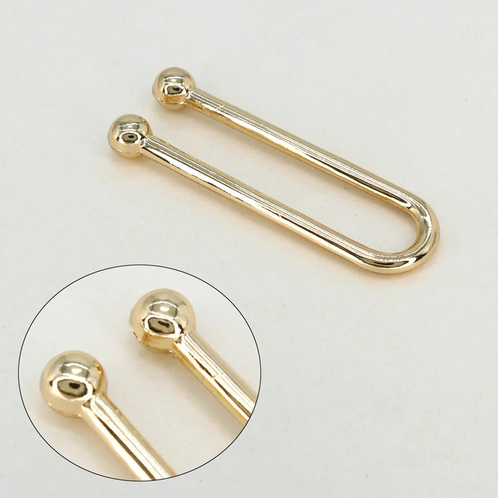 Ani Accessories U-Shaped Elegant Metal Gold Buckle with zooming point shown at the tip of the buckle in the white background.