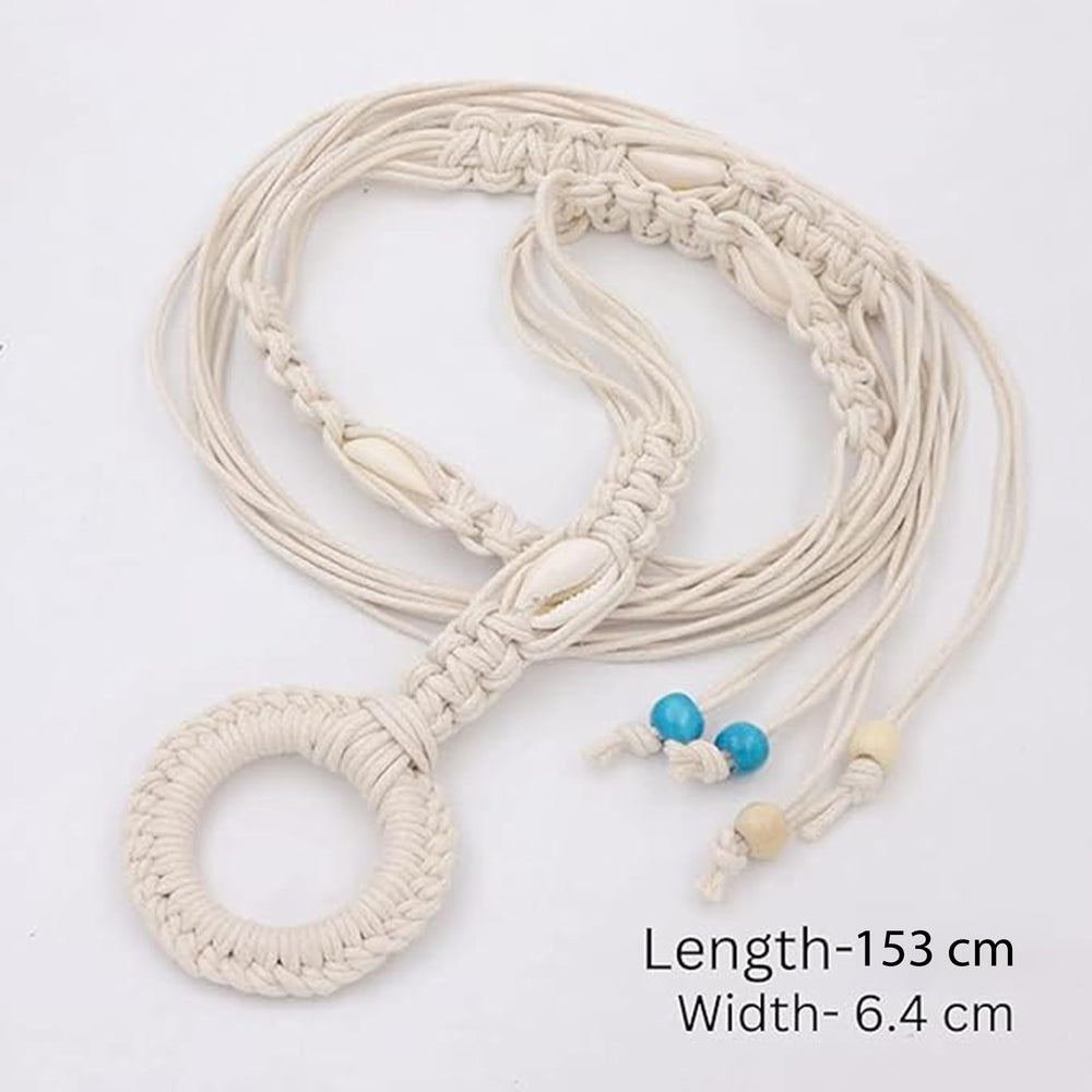 Ani Accessories Womens Belt Beige macrame belt with cowrie shells, styled over a gray dress. The belt threads through a large woven ring and hangs down.