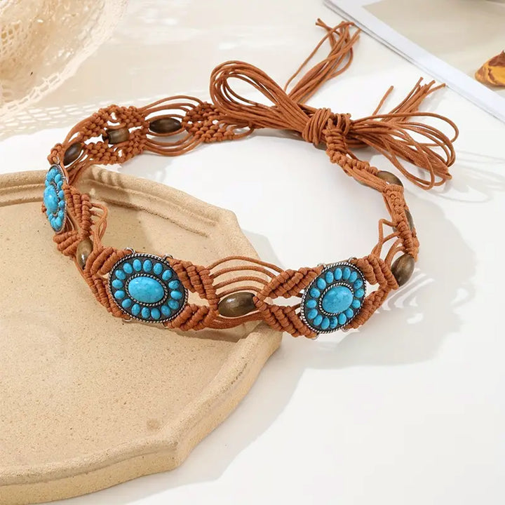 Ani Accessories Womens Belt Close-up of a brown macrame belt with central oval turquoise-colored stone medallions and small wooden beads interwoven into the cord.