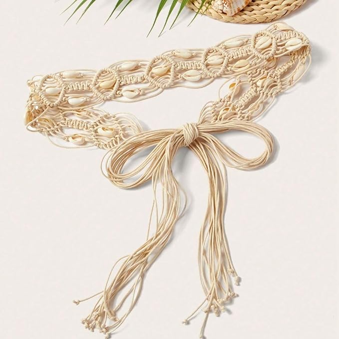 Ani Accessories Womens Belt Close-up of a beige macrame belt featuring cowrie shells. Arrow points to a shell, labeled "Cowrie Shell.