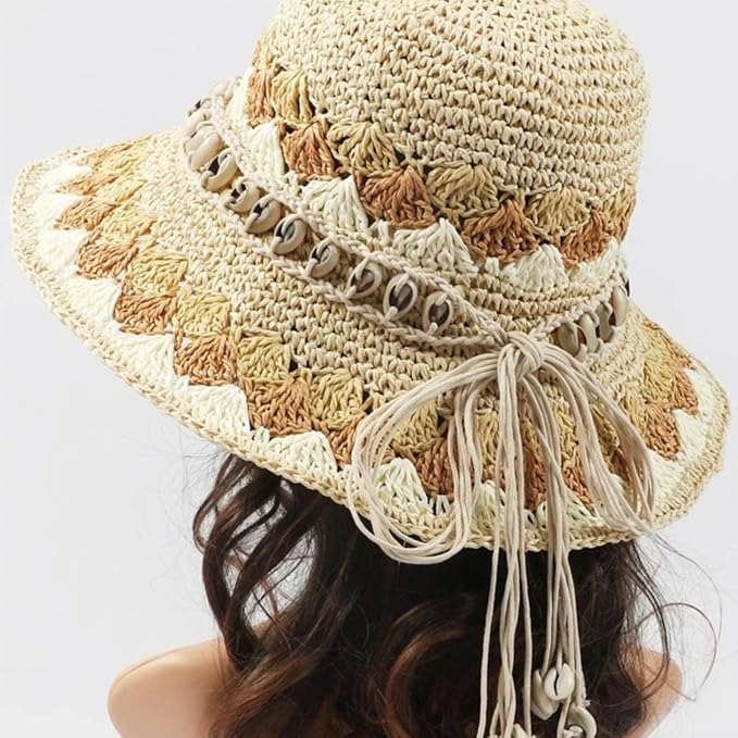 Ani Accessories Womens Belt Straw floppy hat with shades of beige/brown, decorated with a band of cowrie shells and thin tie strings.