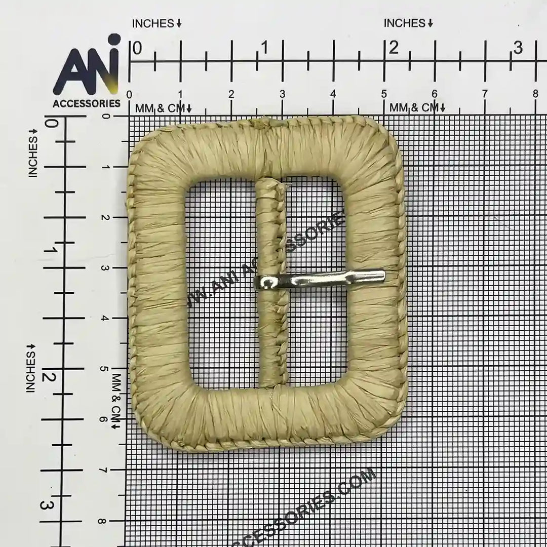 Ani Accessories braided buckle with prong  placed on a size chart bar graph  to show exact size of buckle.   