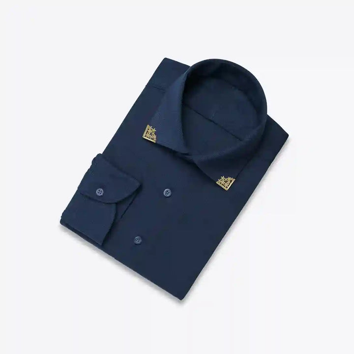 Ani Accessories | Gold Floral collar tip on a folded navy blue shirt.