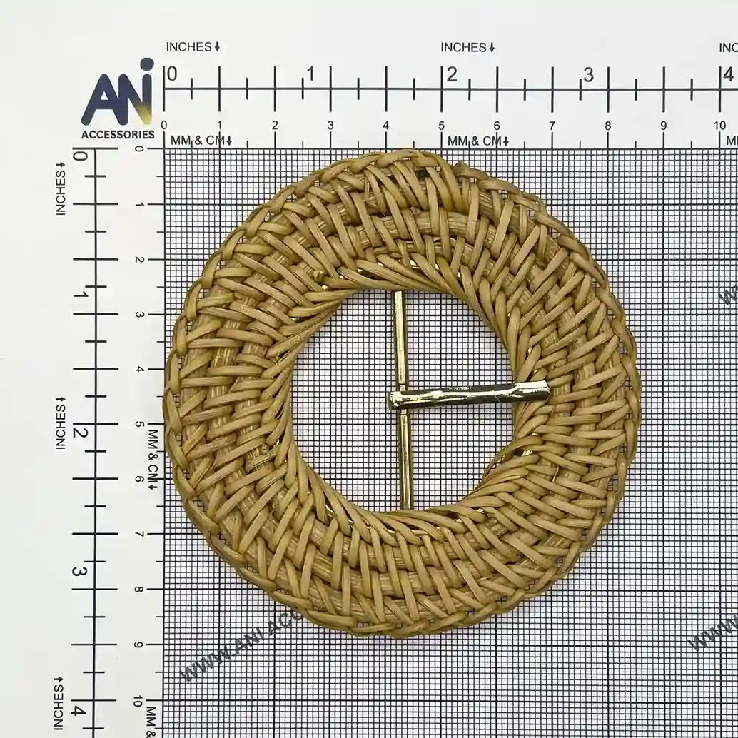 Ani Accessories zooming image of rattan knitting inspired circular raffia buckle with gold prong placed on size chart graph paper