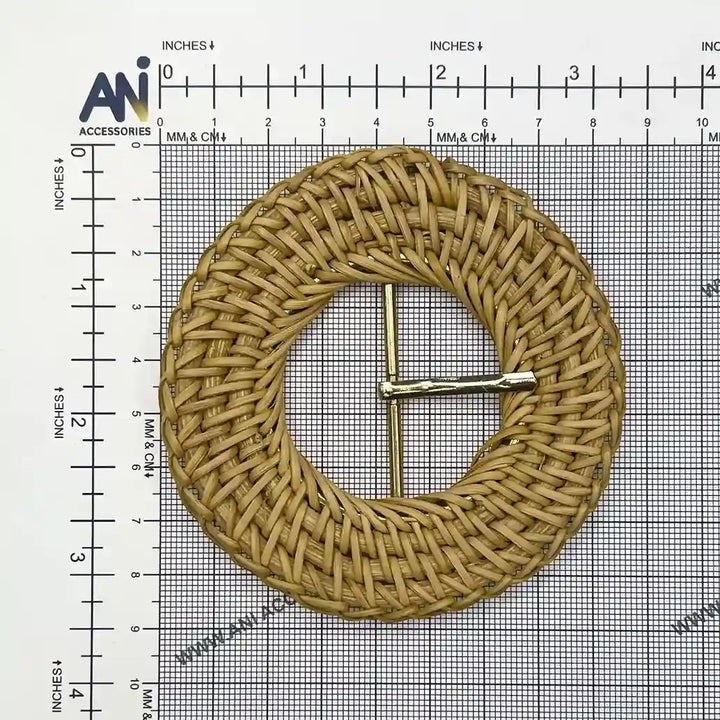 Ani Accessories zooming image of rattan knitting inspired circular raffia buckle with gold prong placed on size chart graph paper
