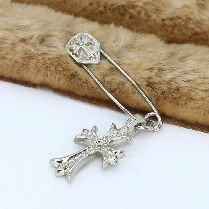 Ani Accessories silver safety pin in cross style placed on fur, perfect for coats, blazers & more.