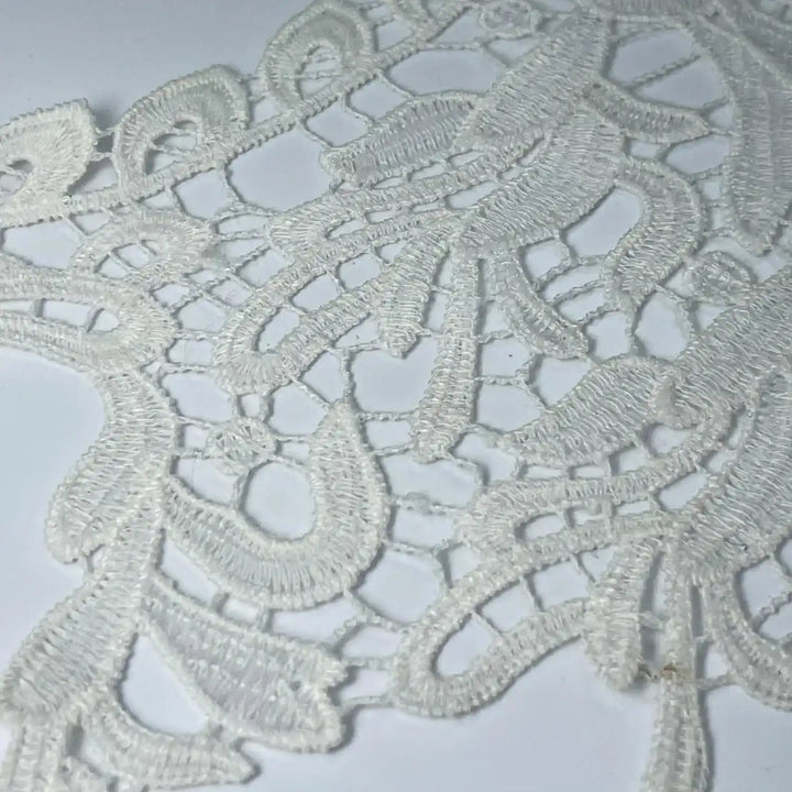 Close-up of round cutwork neckline by Ani Accessories showing detailed craftsmanship on women’s garment