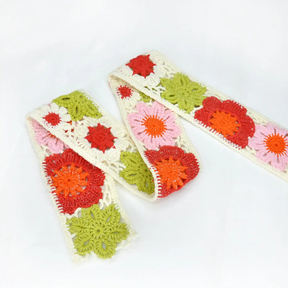 Crochet lace with three color flower patterns on a white background