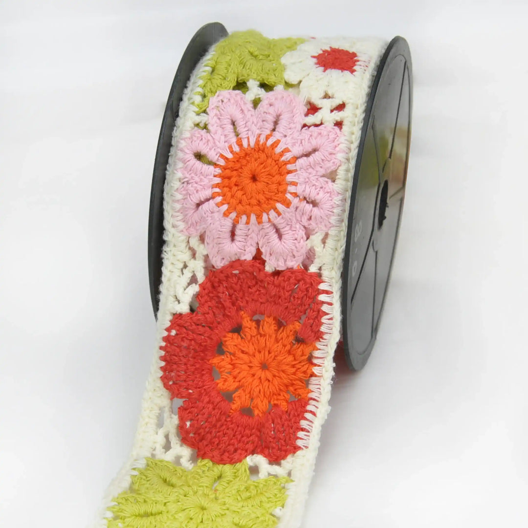 Colorful crochet lace with floral patterns  on lace roll in a white background 