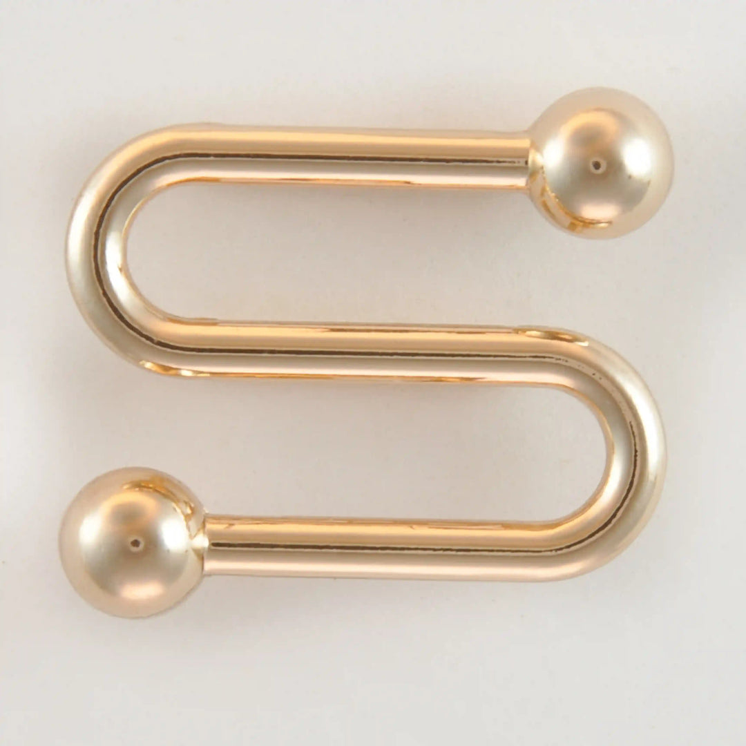 Golden S-shaped handle with balls