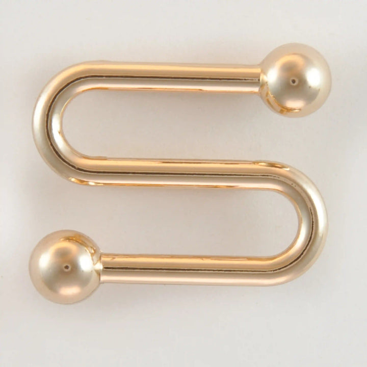 Golden S-shaped handle with balls