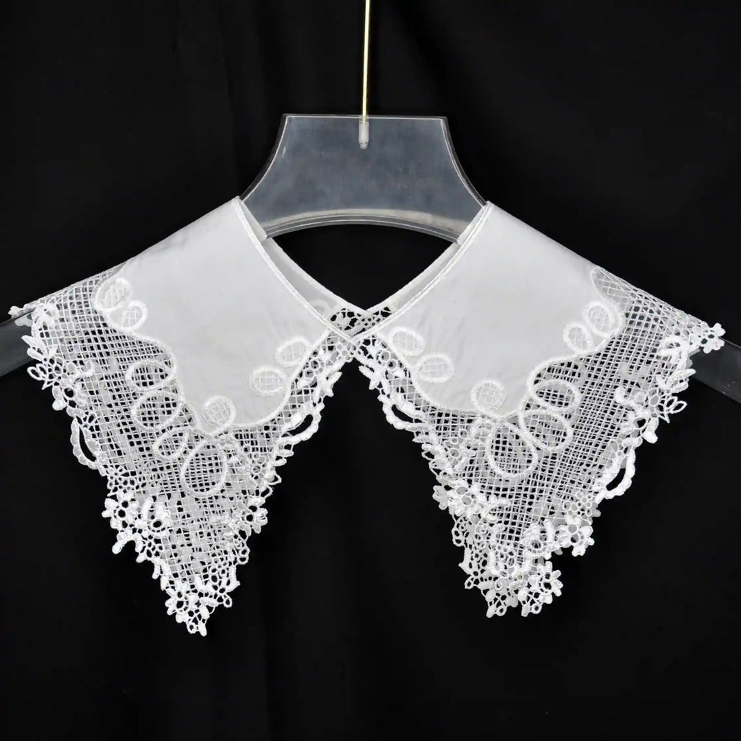 Decorative Pilgrim Flower Peter Pan collar adorned with embroidered flowers and rounded neckline shape