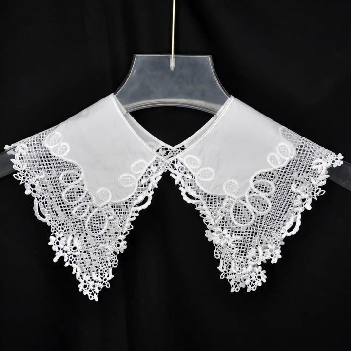 Decorative Pilgrim Flower Peter Pan collar adorned with embroidered flowers and rounded neckline shape