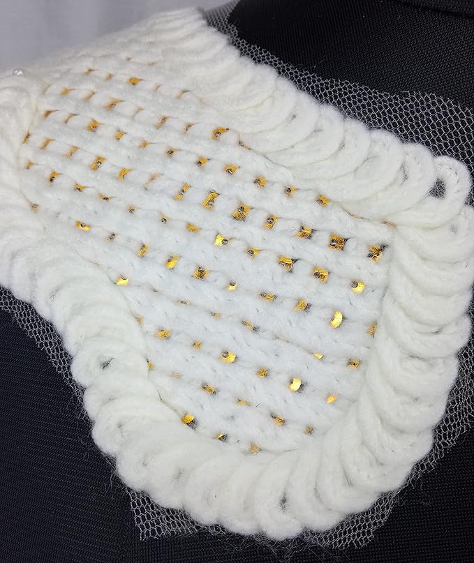 Macro detail of cross design shoulder neckline with shimmering golden sequins and delicate threadwork