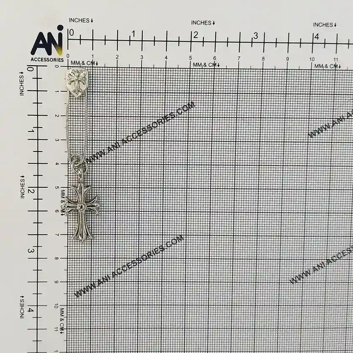 Ani Accessories safety pin placed on graph paper showing size reference for accurate measurement and clear detailing.