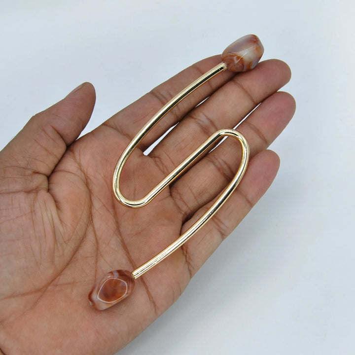 S-Shaped Buckle with Amber Accents Design