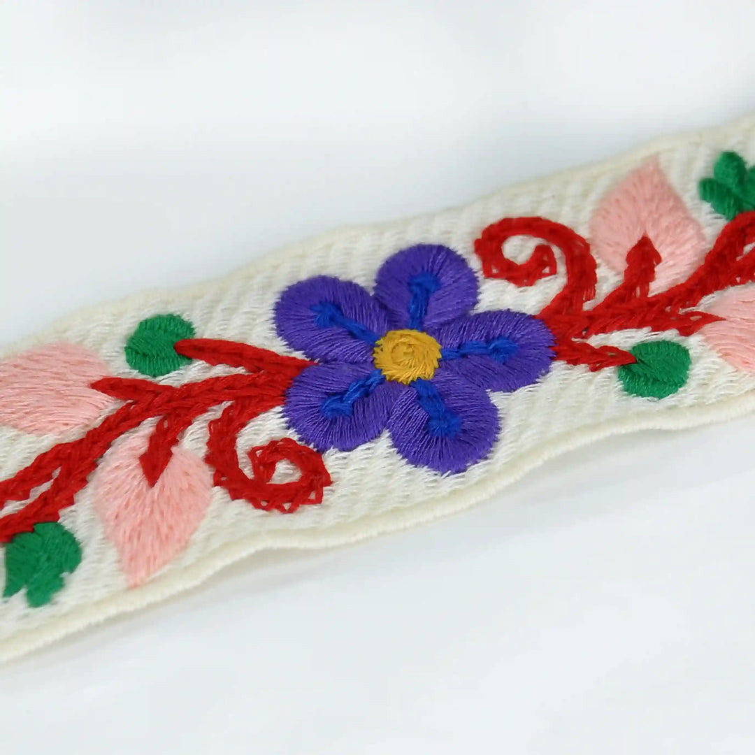 Extreme zooming image of Embroidered floral design crochet with a purple flower on a white background | Ani Accessories 