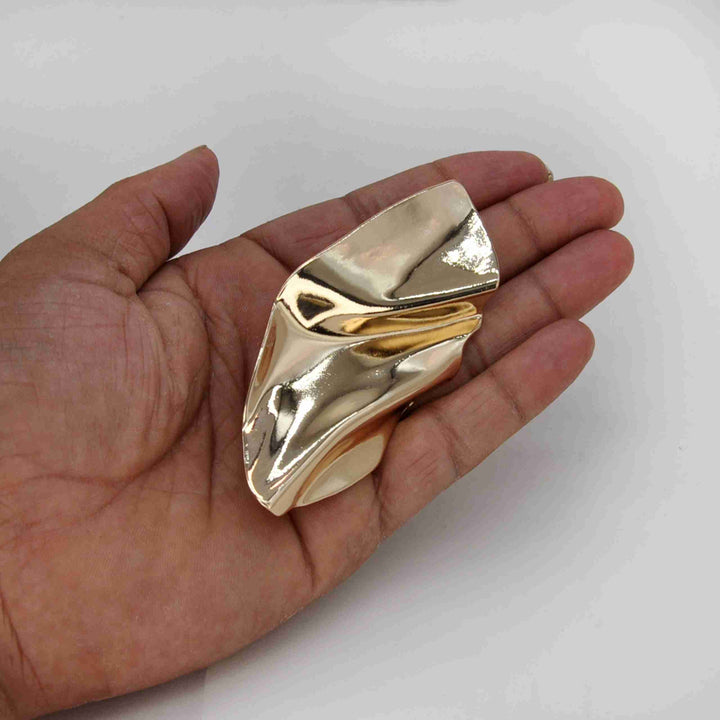 ANI Accessories abstract leaf buckle held in hand to show its size 