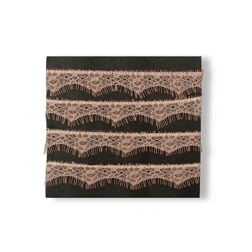 Buy now Peach Eyelash Trim Lace Fabric by Ani Accessories with delicate wave patterns and fringing details
