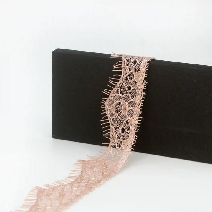 Buy now Peach Eyelash Trim Lace Fabric from Ani Accessories with delicate floral patterns and soft texture