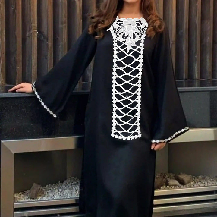 ANI Accessories model wearing a black kaftan styled with a white floral cross style front panel neck patch, perfect for abaya and kaftan necklines 