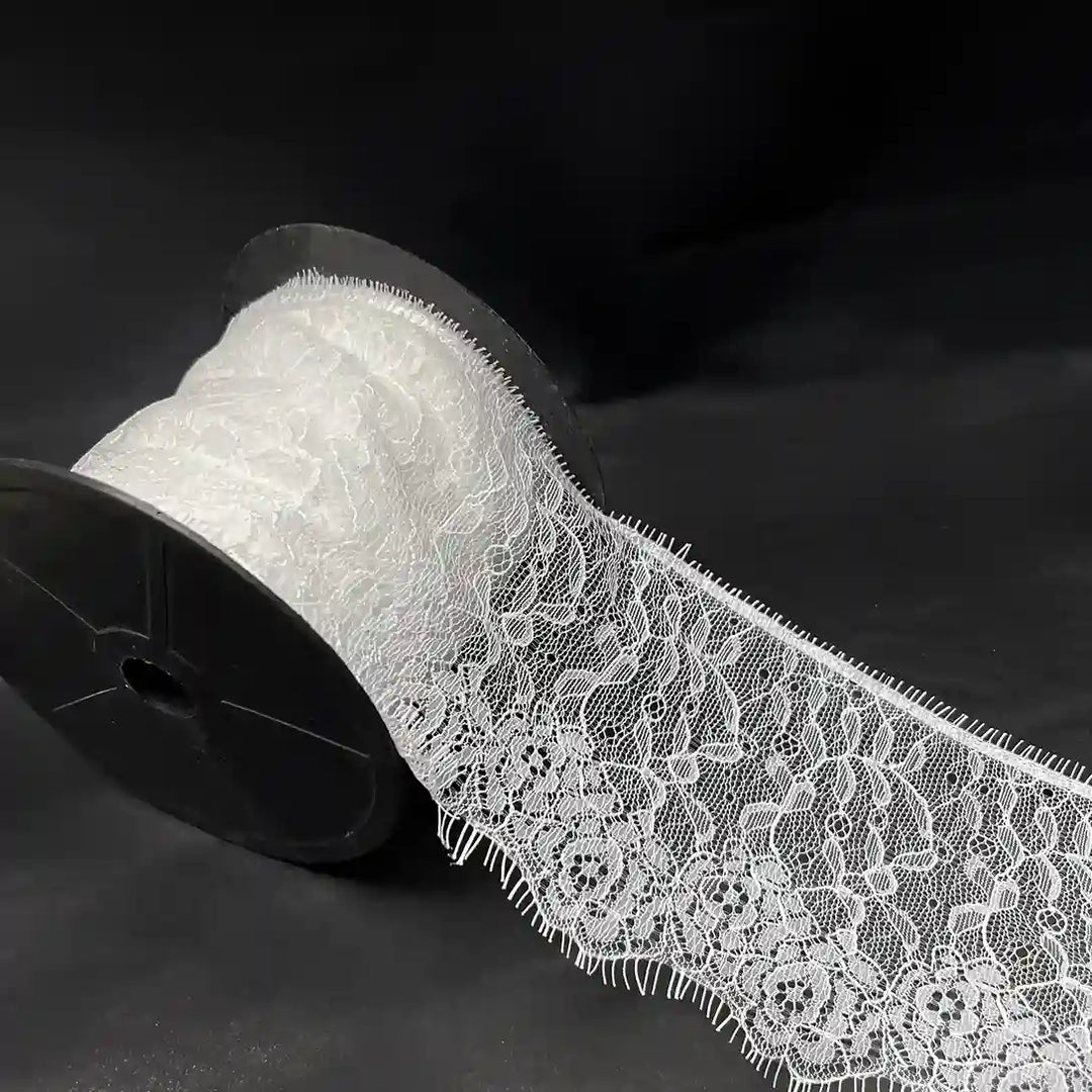 Rose Garden Eyelash Lace applique by Ani Accessories on a spool, featuring intricate floral designs