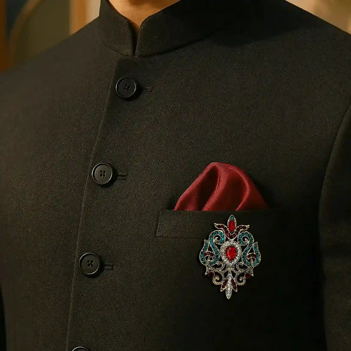 ANI Accessories antique gold brooch on the chest of a dark green jodhpuri suit