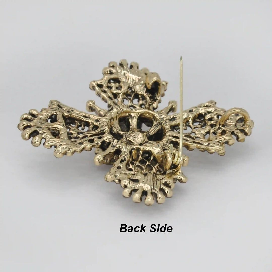 ANI Accessories baroque cross brooch back side showing the antique gold base and pin 