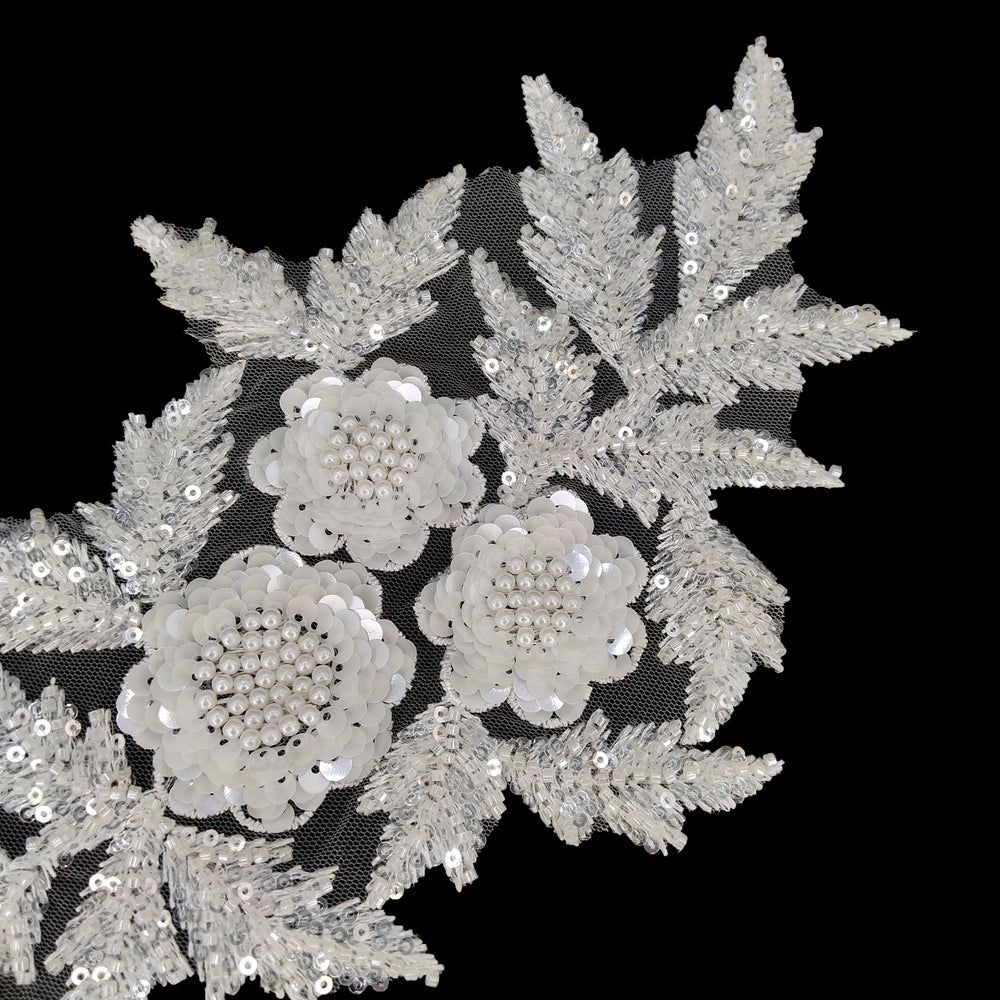ANI Accessories beaded applique patch with fern-like bead-filled leaves, angled view on black Background 