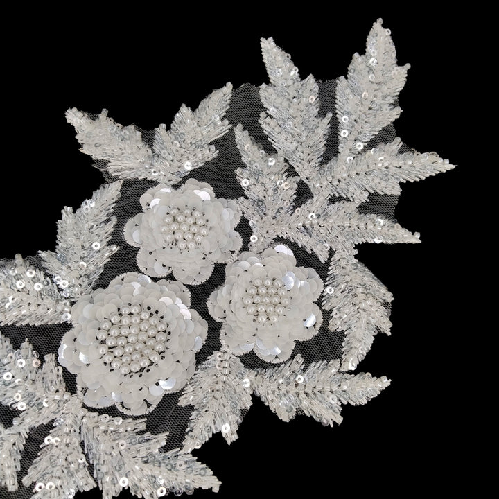 ANI Accessories beaded applique patch with fern-like bead-filled leaves, angled view on black Background 